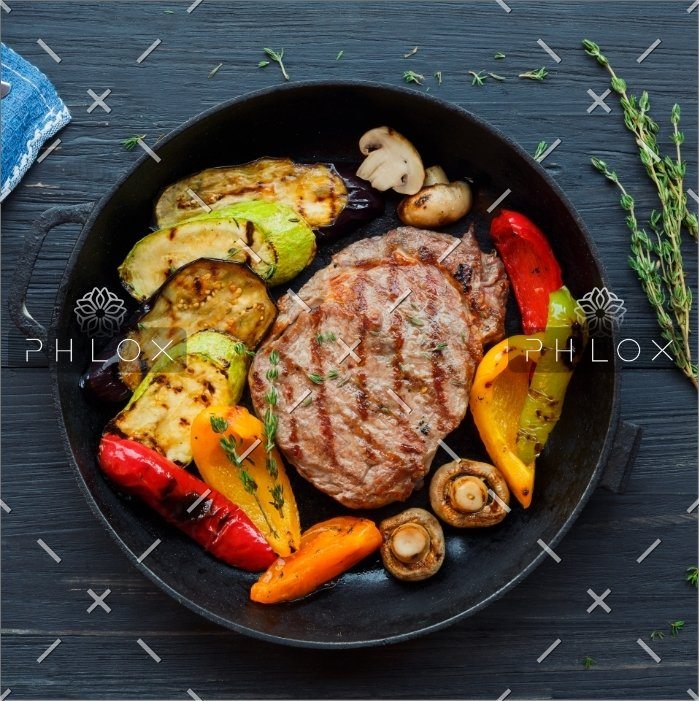 grilled-beef-steak-on-dark-wooden-table-P4NLM25.jpg